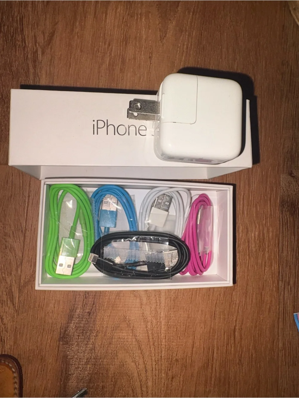 5 collared USB to type A iPhone charging cords and a USB charging block